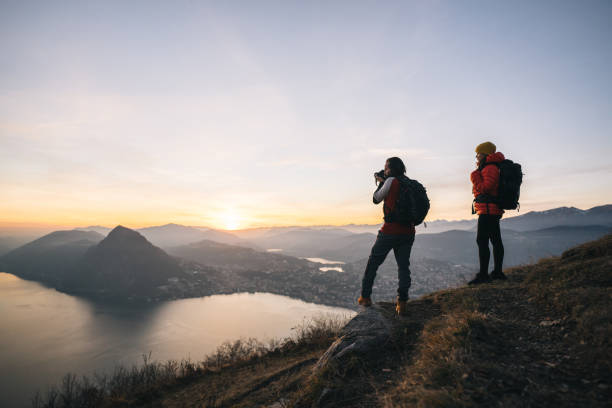 istock Hiking couple relax on grassy mountain ridge 1361420312