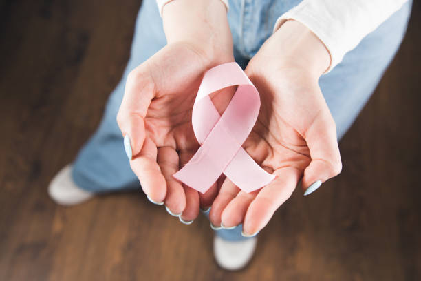 istock young girl holds a pink ribbon 1361421006