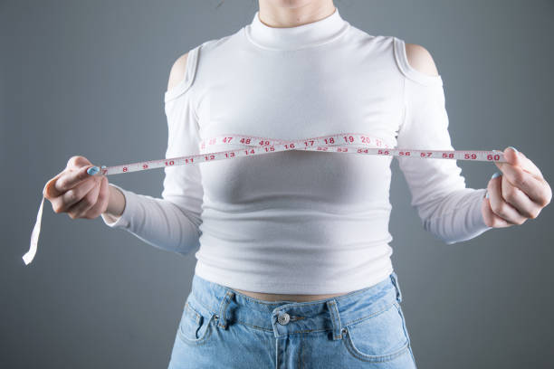 istock young girl measures breast girth 1361421015