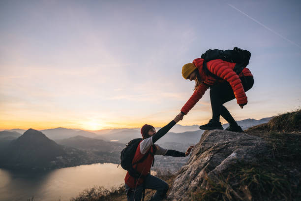 istock Hiking couple climb up mountain ridge 1361421116