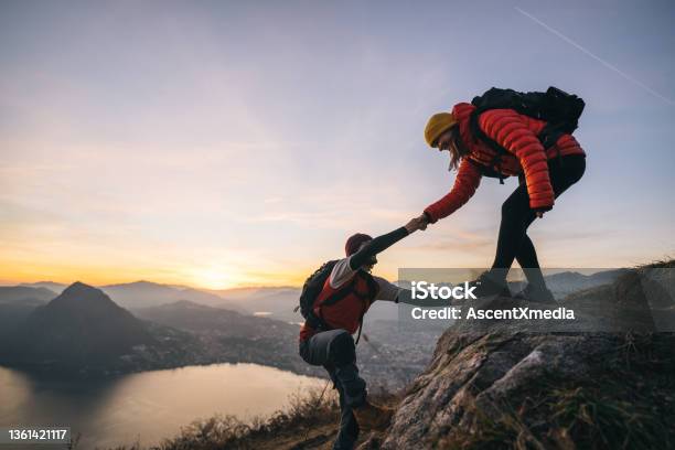 Hiking Couple Climb Up Mountain Ridge Stock Photo - Download Image Now - Teamwork, Mountain Climbing, Hiking