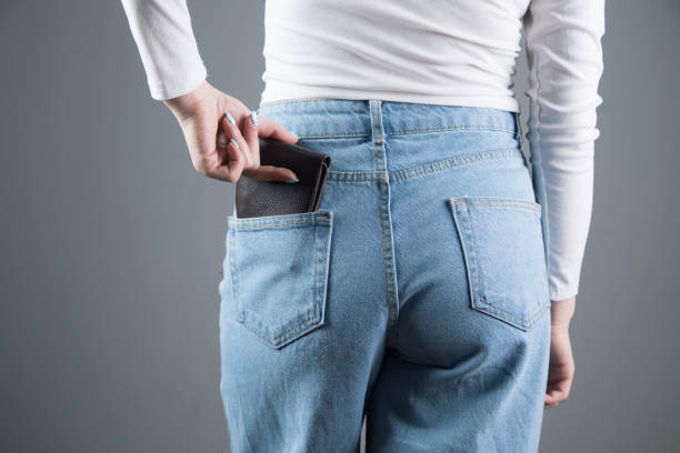 istock young woman pulls out her wallet from her pocket 1361422413