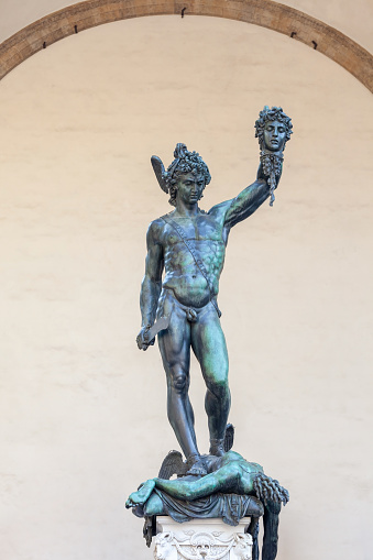 Street statue of Perseus with the Head of Medusa in Florence, Italy. The statue was created by Benvenuto Cellini in 1554 and stays on the street near the Palazzo Vecchio and Piazza della Signoria.