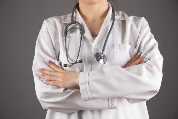 istock a doctor with a stethascope stands by crossing his hands 1361424291