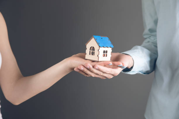 istock couple holds a house in their hands 1361424858