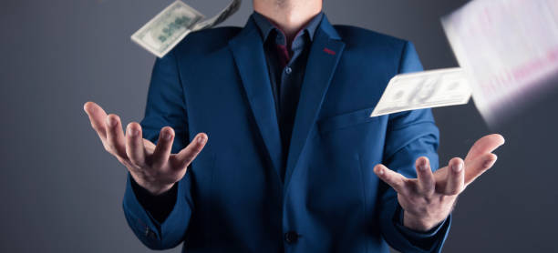 istock money falls on a man in a suit 1361424860
