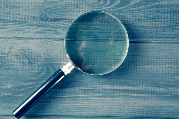 istock magnifying glass on gray wooden background 1361425632