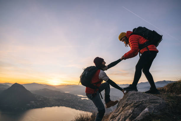istock Hiking couple climb up mountain ridge 1361427482