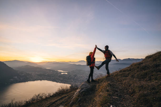 istock Hiking couple high-five on mountain ridge 1361428454