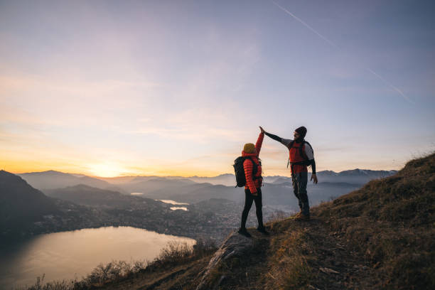 istock Hiking couple high-five on mountain ridge 1361430148