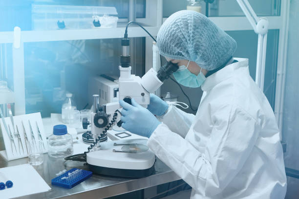 istock Young scientist looking through a microscope in a laboratory. Medical Research Laboratory. 1361433374