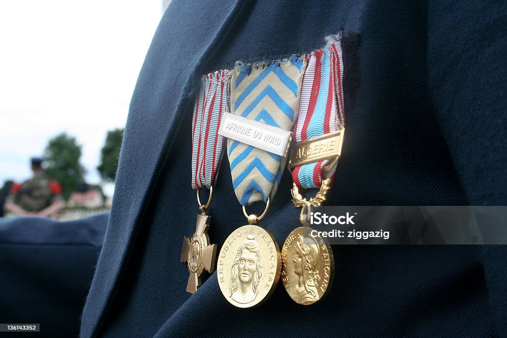 French Veteran Soldier Medals from World War 2 A French veteran soldier shows off his WW2 medals as he shakes hands with a Canadian high school student - Canadian war cemetery, Normandy, France. French Military Stock Photo