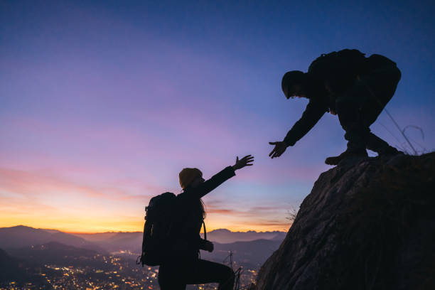 istock Hiking couple climb up mountain ridge 1361436432