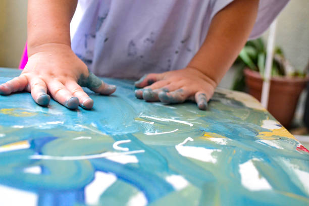 istock Girl's hands painting 1361436613