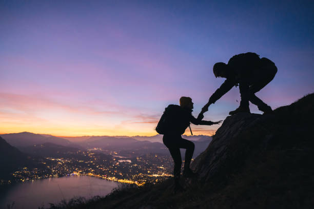 istock Hiking couple climb up mountain ridge 1361436637