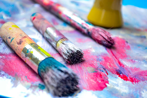 istock Girl's hands painting 1361437690