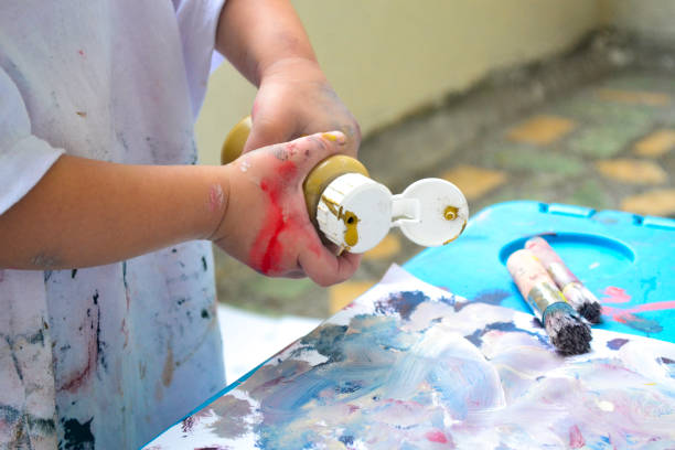 istock Girl's hands painting 1361437774