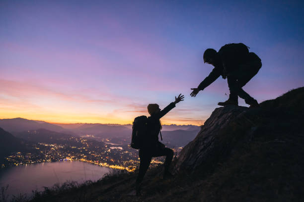 istock Hiking couple climb up mountain ridge 1361437822