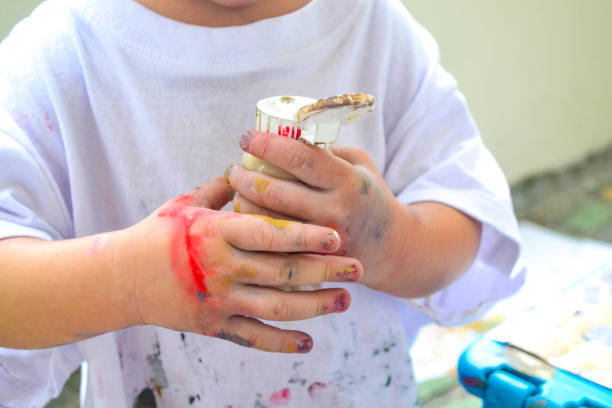 istock Girl's hands painting 1361437865