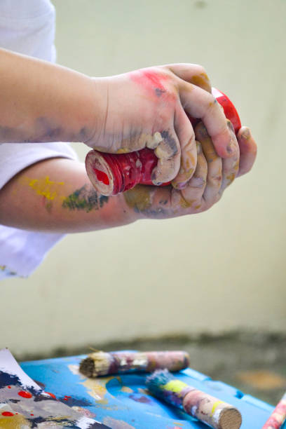 istock Girl's hands painting 1361437868