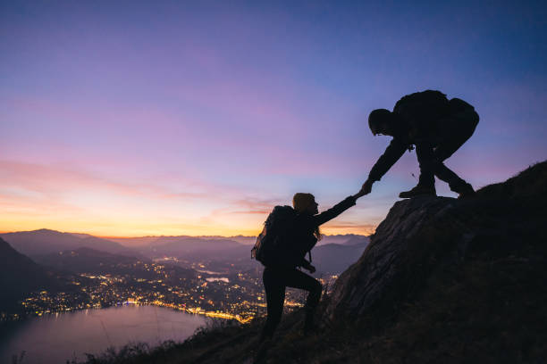 istock Hiking couple climb up mountain ridge 1361437896