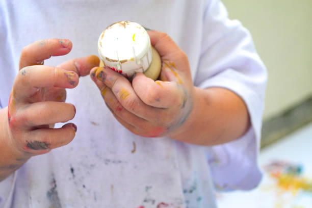 istock Girl's hands painting 1361438627