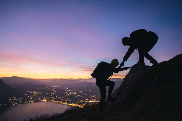 istock Hiking couple climb up mountain ridge 1361438691