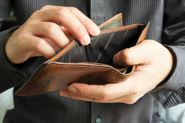 istock The young man's hand opened his wallet without money. 1361441842