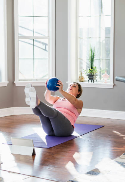 istock Hispanic woman doing home workout, core exercises 1361442076