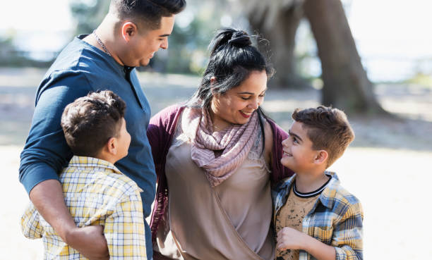 istock Hispanic family, two boys outdoors, smile at each other 1361443433