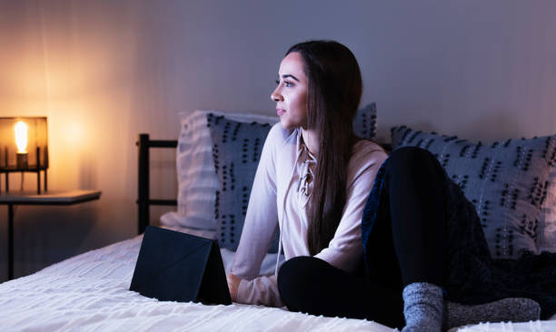 istock Young multiracial woman on bed using digital tablet 1361443445