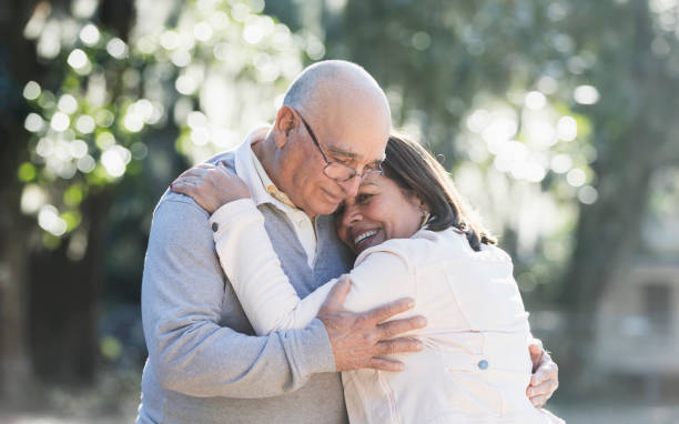 istock Senior Hispanic couple hugging in park on sunny day 1361443534