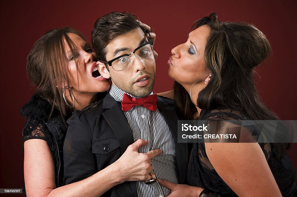 Two older women with a shy young man Two aggressive cougar women corner a shy young man 20-29 Years Stock Photo