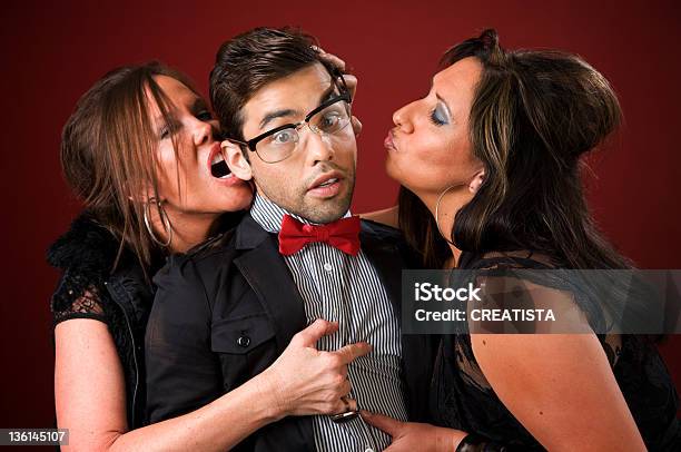 Two Older Women With A Shy Young Man Stock Photo - Download Image Now - 20-29 Years, Adult, Affectionate