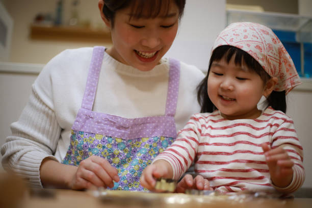 istock Parents and children making sweets 1361451259
