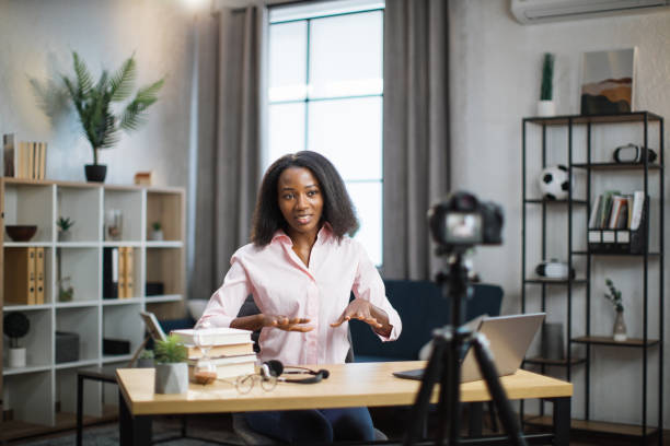 istock African woman using camera for live stream at home 1361456921