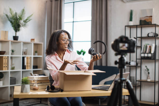istock African woman recording video while unpacking box 1361456962