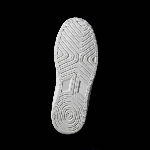Sole of sports shoe. White. Frontally on a black background. Square format