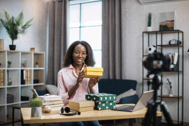 istock African woman recording video while unpacking gift boxes 1361456984