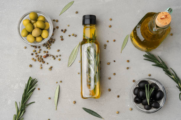 istock Glass bottle with olive oil on gray background 1361462970