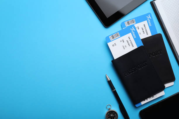 istock Flat lay composition with avia tickets and passports on light blue background, space for text. Travel agency concept 1361463982