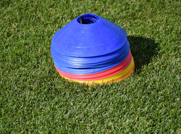 istock Plastic baffles on the grass of the soccer field 1361464010