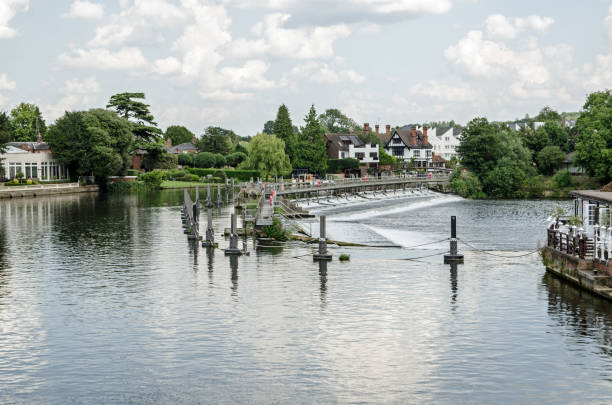 View from the suspension bridge of the weir on the River Thames at Marlow, Buckinghamshire on a sunny summer day.