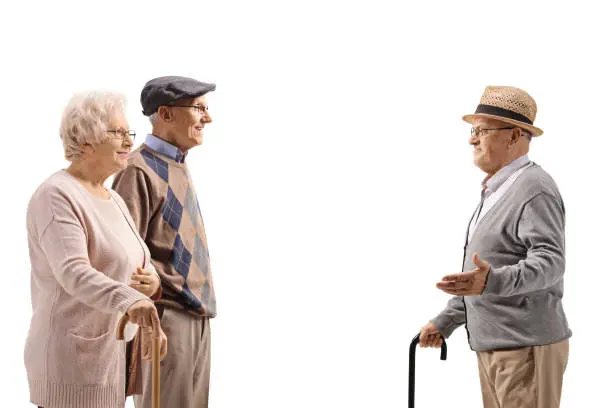 Edlerly man talking to an elderly couple isolated on white background