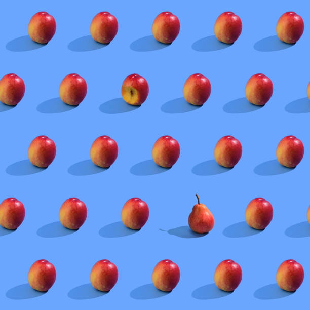 istock Seamless nectarine pattern with hard shadow. One bit off nectarine. One yellow-red pear in one line. 1361469150