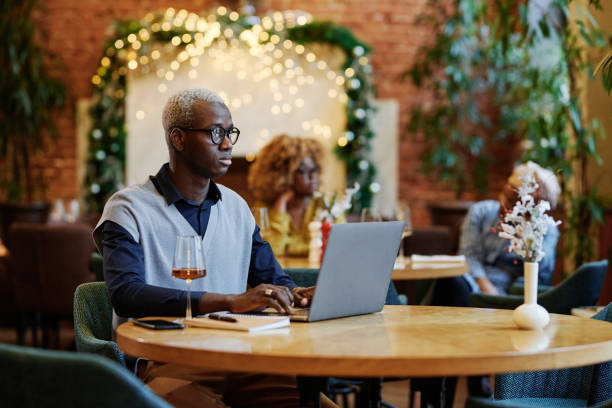 istock Businessman working on laptop in cafe 1361474935
