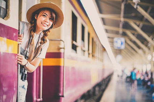 Woman traveler tourists travel city street, journey backpack adventure outdoor by train.