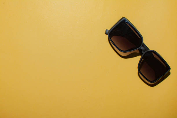 istock Black glasses on a yellow background. Layout for designers 1361477044
