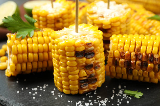 istock Tasty grilled corn on black plate, closeup 1361478177