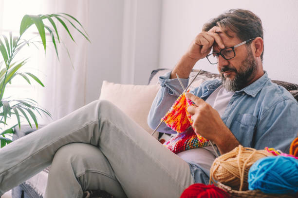 istock Full Length Of Man Sitting On Sofa At Home 1361480702